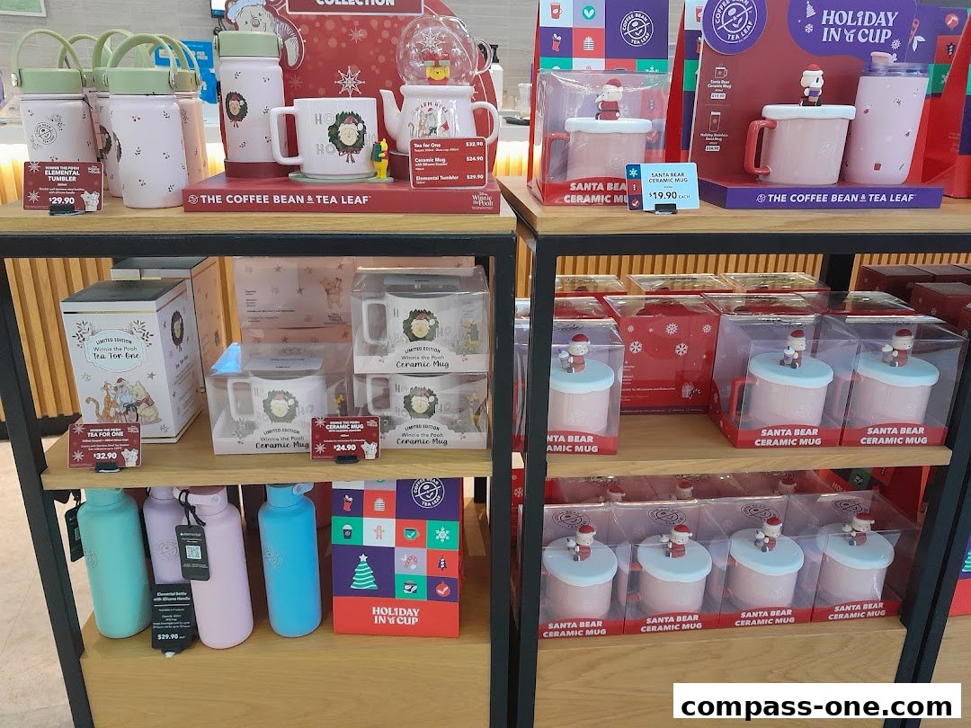 Display of holiday-themed mugs, tumblers, and tea sets from The Coffee Bean & Tea Leaf.