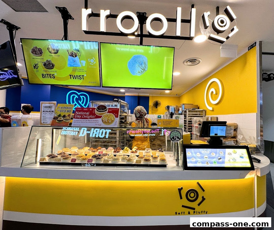 A brightly lit bakery counter displaying a variety of sweet rolls and pastries.