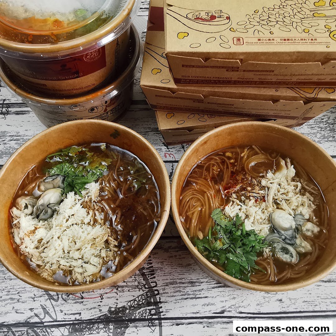 Two bowls of Taiwanese oyster mee sua and takeout boxes from Shihlin Taiwan Street Snacks.