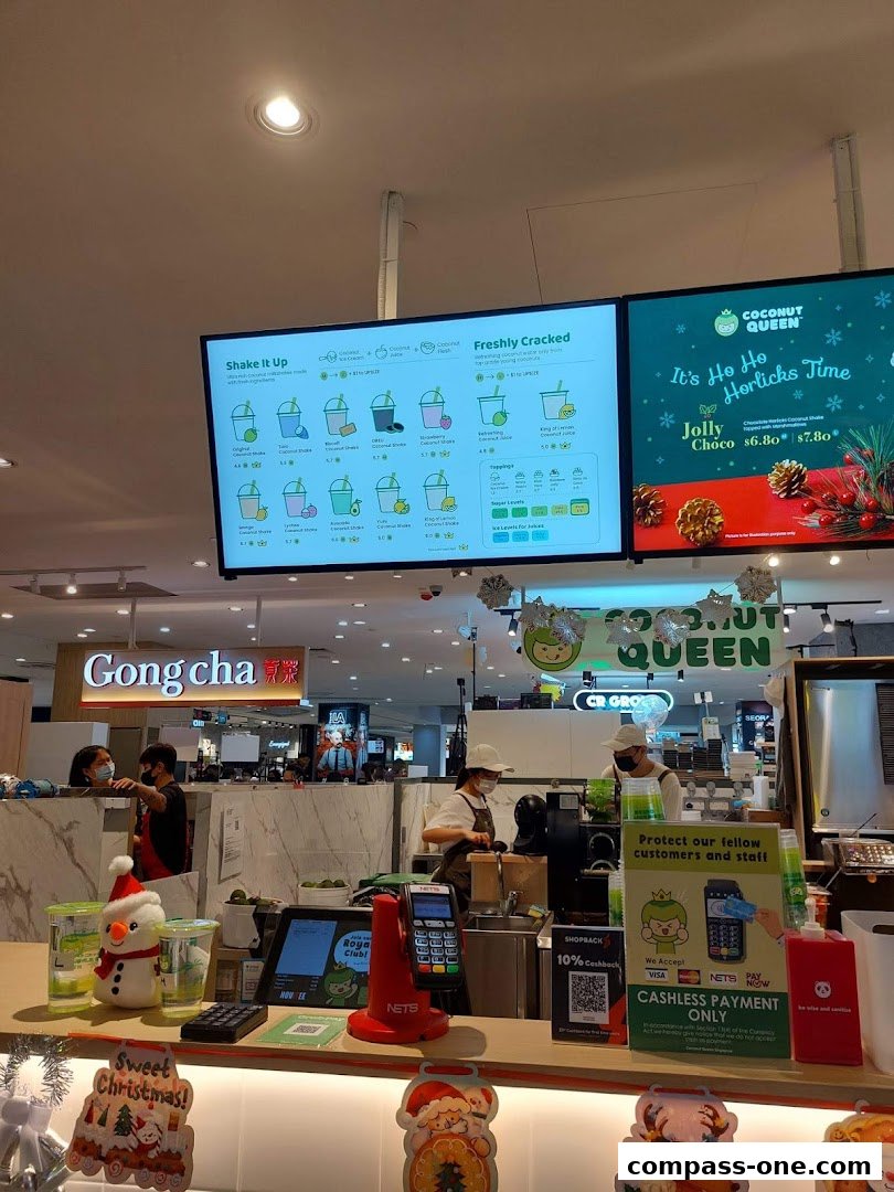 A menu board displays various coconut drinks and a holiday special at Coconut Queen.