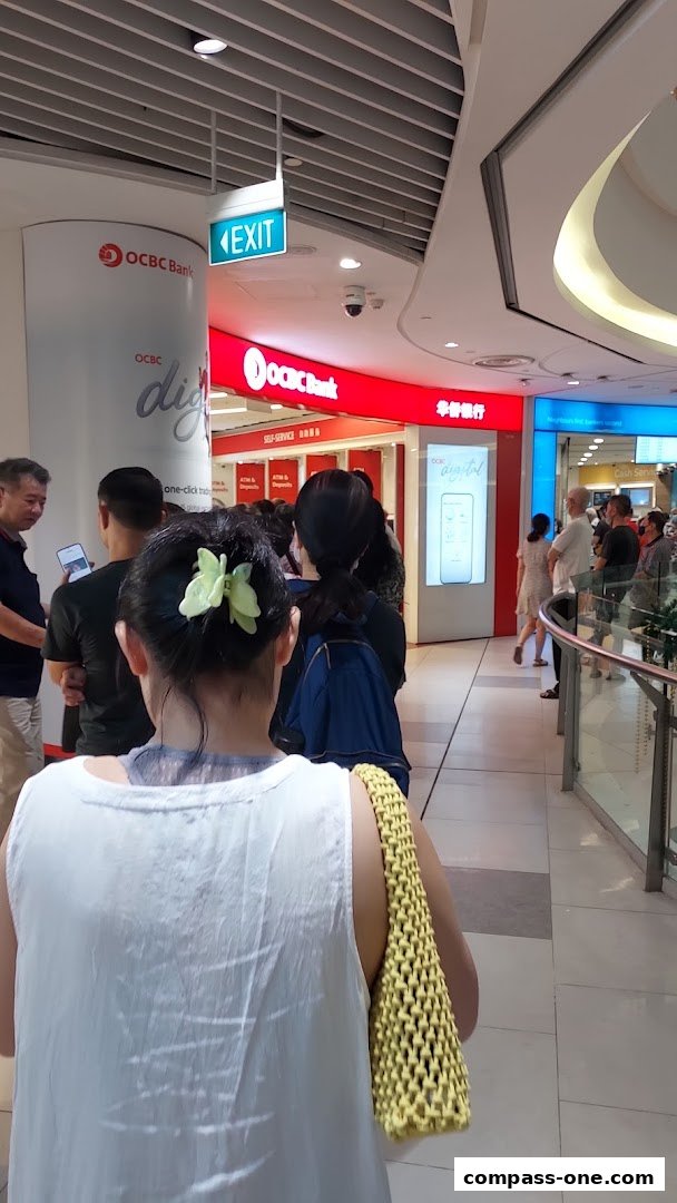 People queuing at the OCBC Bank branch in a shopping mall.