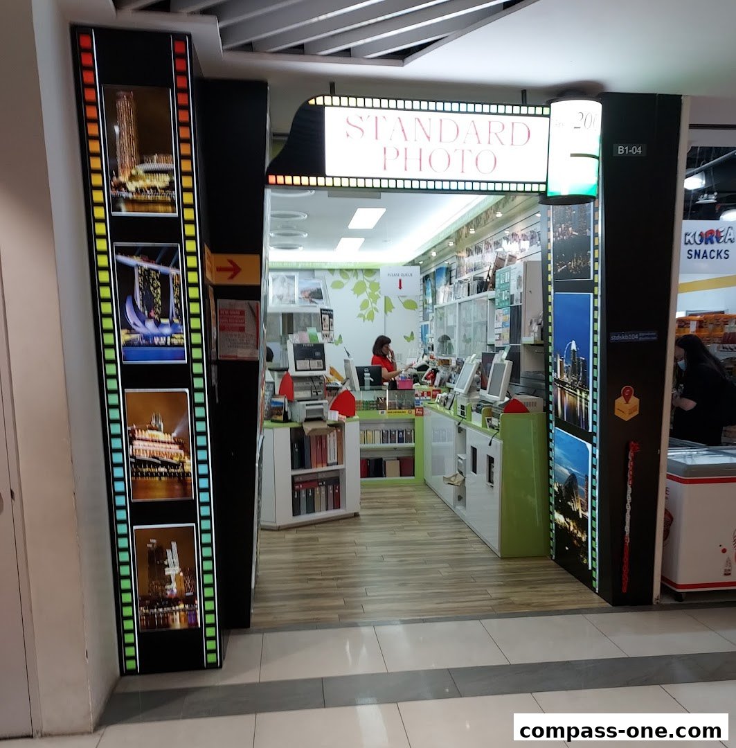 The entrance to Standard Photo, a shop with a film strip design and city skyline images.