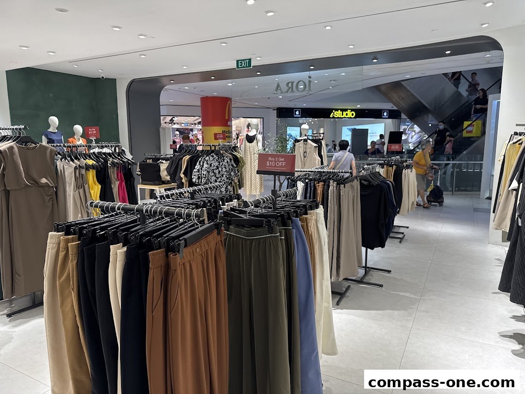 Interior view of a clothing store with racks of apparel and mannequins.