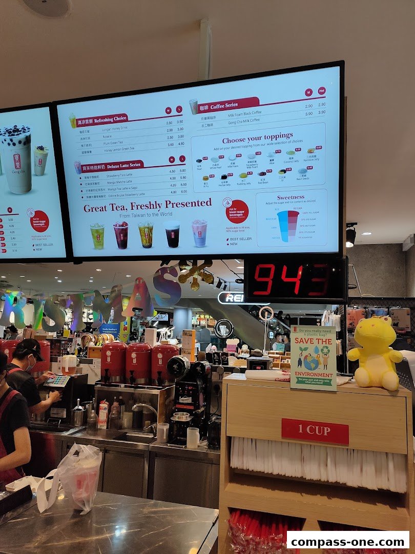 A digital menu board displays various bubble tea options, toppings, and sweetness levels at Gong Cha.