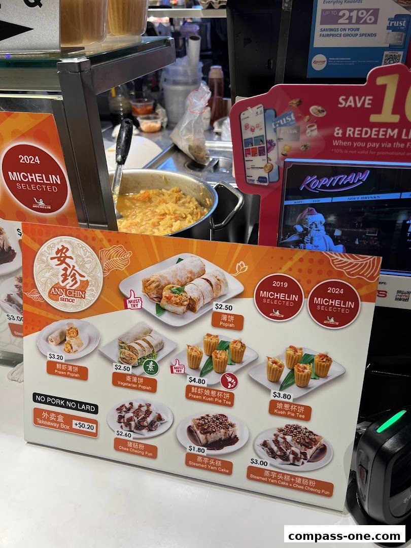 A menu board displaying various popiah and kueh pie tee dishes with prices and Michelin selections.