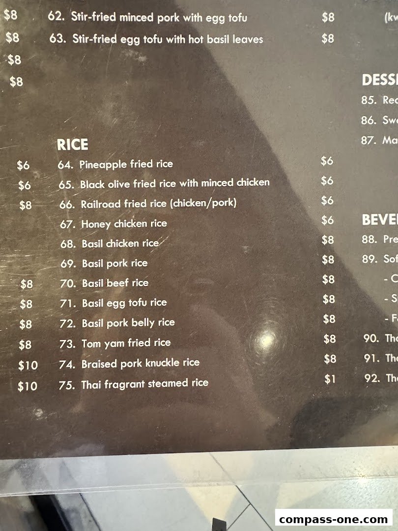 A close-up of a menu featuring Thai rice dishes and other items with prices.