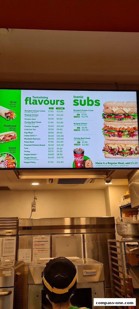 A digital menu board displaying Subway's "Tantalising Flavours" and "Iconic Subs" with prices and images.
