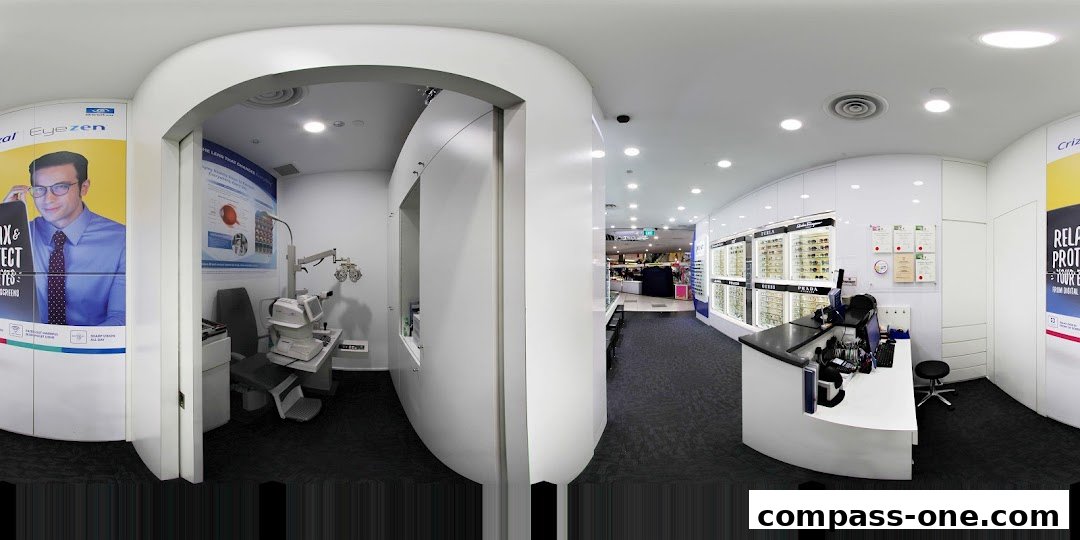Interior view of an optical shop with an eye examination room and a display of eyeglasses.