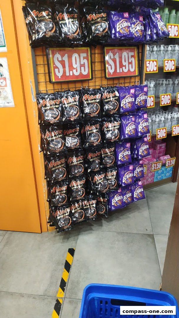 A display of Mars miniatures and Cadbury Eclairs chocolates with price tags.