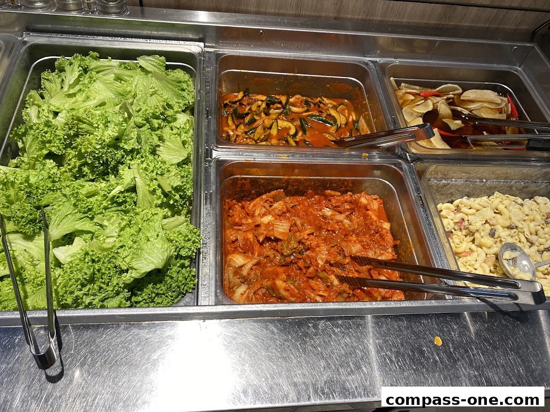 A selection of Korean side dishes including lettuce, kimchi, and macaroni salad.