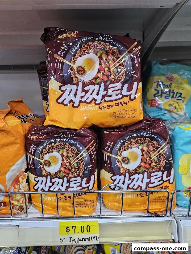 Packs of Korean instant noodles, specifically Jjajangmyeon, are displayed on a shelf with a price tag.