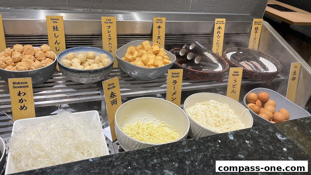 A variety of ingredients for hot pot, including tofu, fish balls, noodles, and eggs.