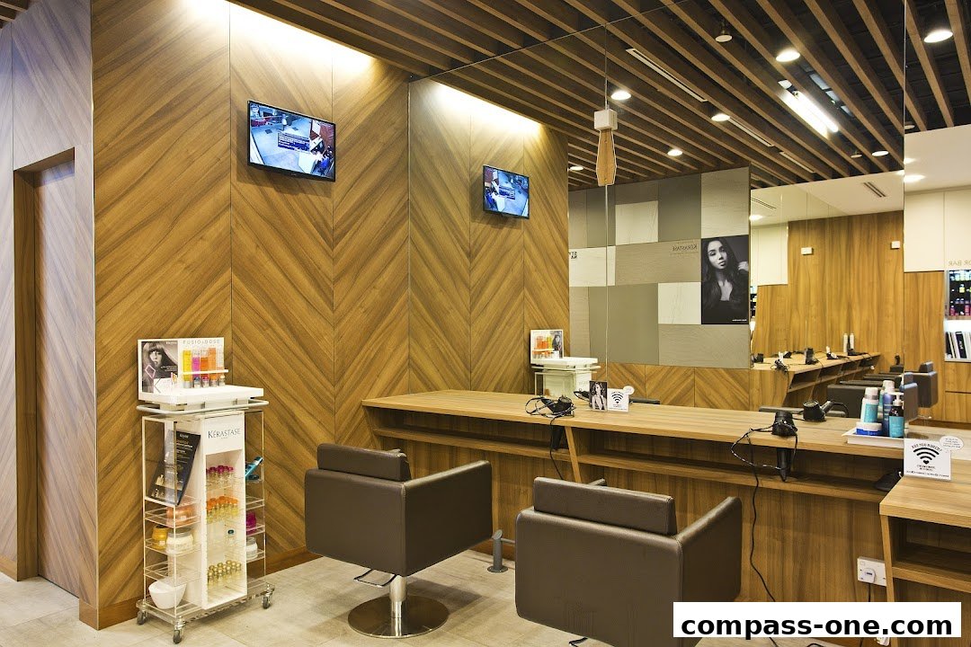 Interior of a modern hair salon with styling chairs, mirrors, and product displays.