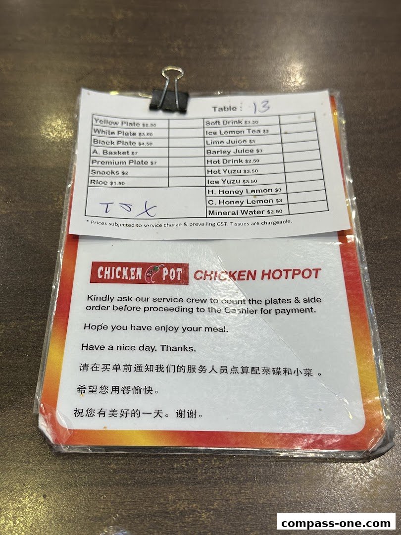 A menu from Chicken Hotpot with various dishes and drinks listed with prices.