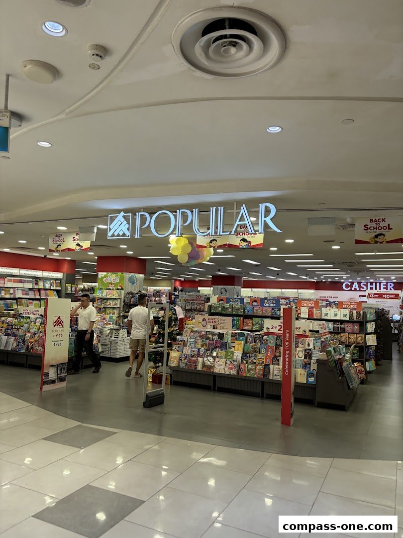 The entrance of a POPULAR Bookstore, filled with books and promotional displays.