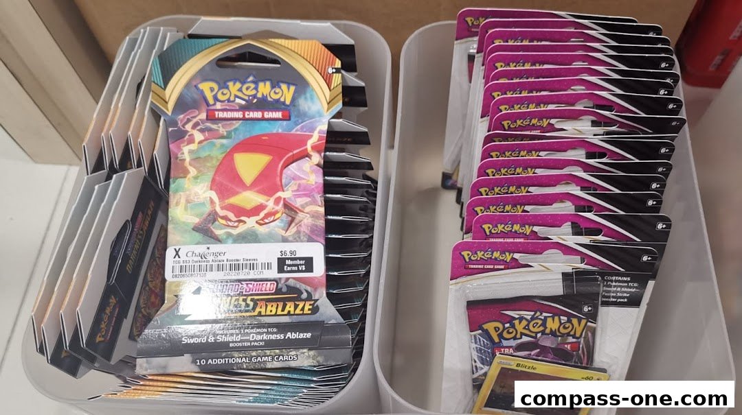 Packs of Pokemon trading cards and booster sleeves are displayed in white organizers.