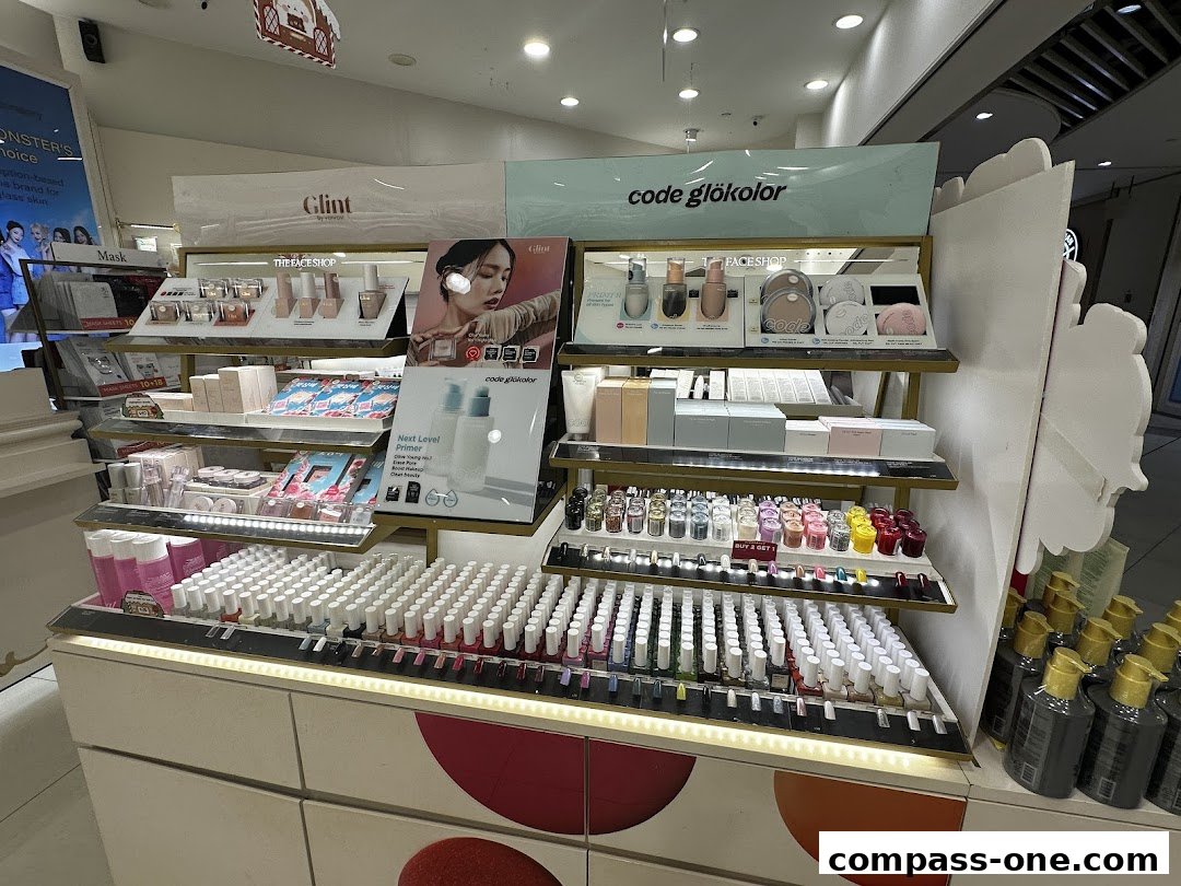 A display of various beauty products, including nail polish, primers, and skincare, at THEFACESHOP.