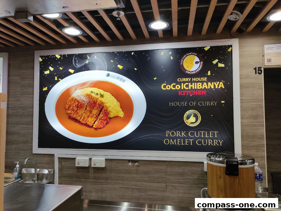 A large advertisement for CoCo Ichibanya's Pork Cutlet Omelet Curry.