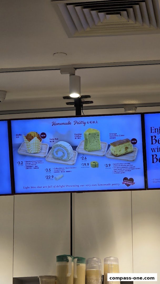 A digital menu board displaying various homemade pastries with prices.