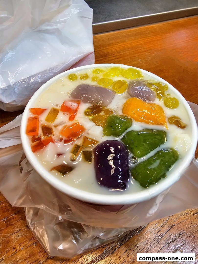 A bowl of colorful Taiwanese dessert with various toppings and a plastic bag in the background.