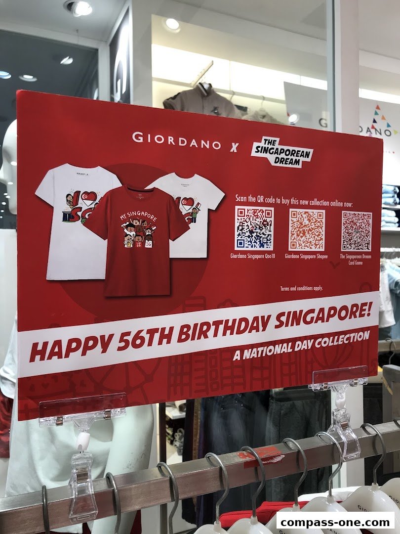 Giordano store display featuring a National Day collection with t-shirts and QR codes.