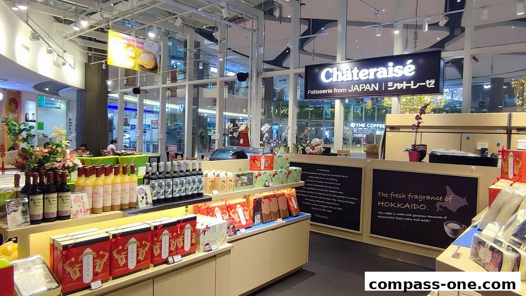 Interior view of a Châteraisé patisserie shop with various confectionery and bottled drinks on display.