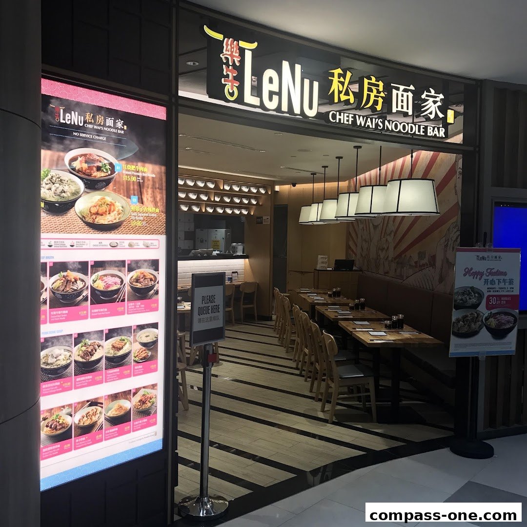 The entrance of LeNu Chef Wai's Noodle Bar with a digital menu display and seating area visible.