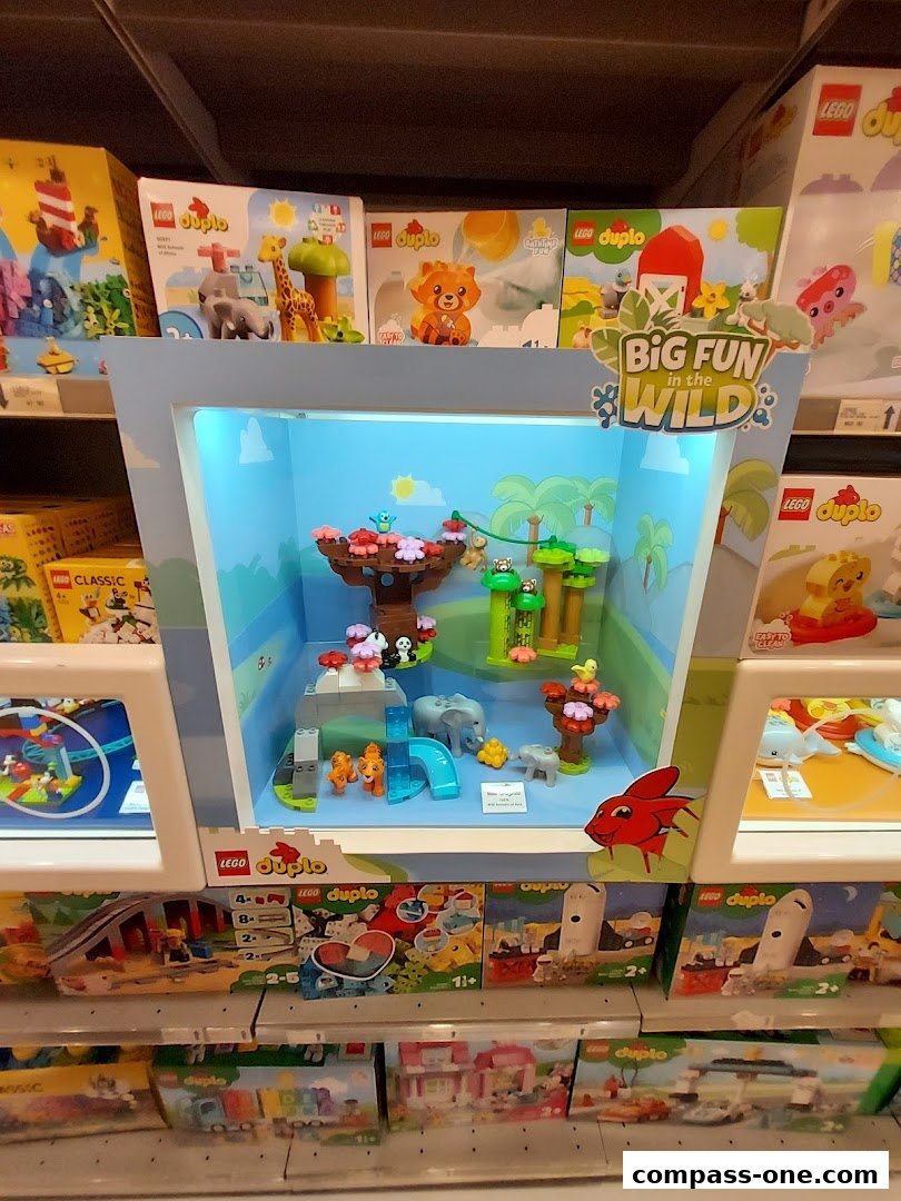 A display case showcasing LEGO Duplo 'Big Fun in the Wild' playsets with various animal figures.