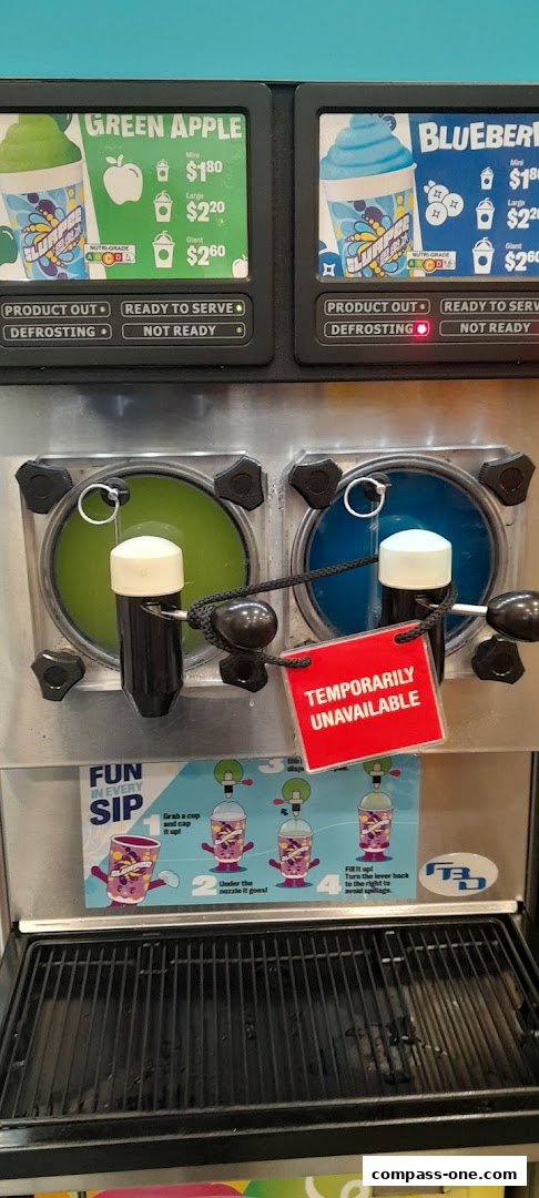 A 7-Eleven Slurpee machine with Green Apple and Blueberry flavors, one is temporarily unavailable.