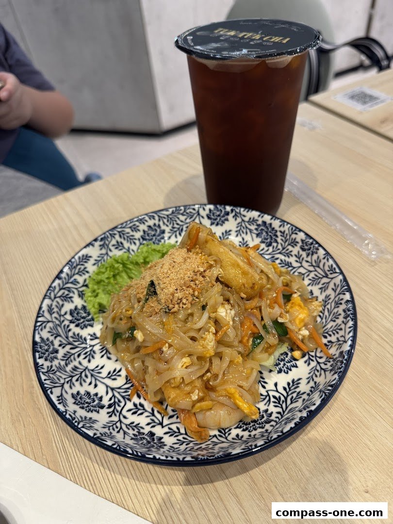 A plate of Pad Thai noodles and a large iced drink from Tuk Tuk Cha Treasures.
