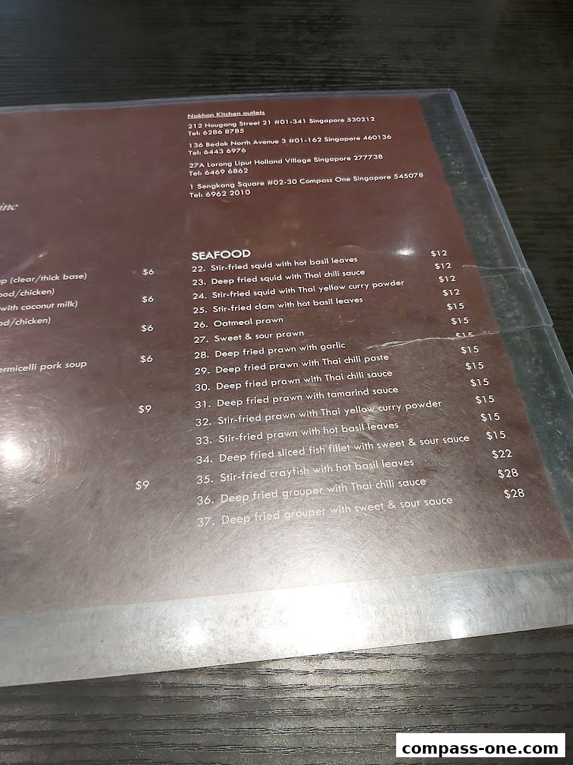 A menu from Nakhon Kitchen showing various seafood dishes with prices.