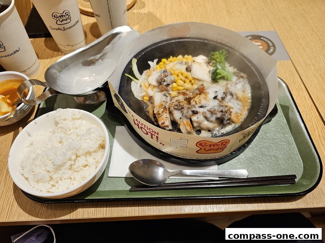 A sizzling hot plate meal with chicken, corn, broccoli, and rice at Pepper Lunch.