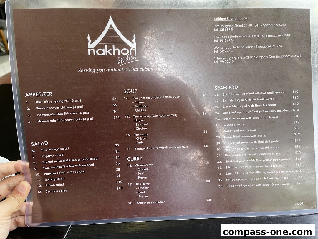 A menu from Nakhon Kitchen, featuring Thai cuisine with appetizers, salads, soups, curries, and seafood dishes.