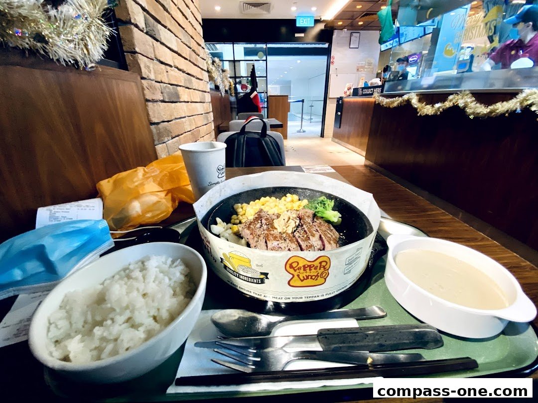 A sizzling steak meal with rice and soup served at Pepper Lunch.