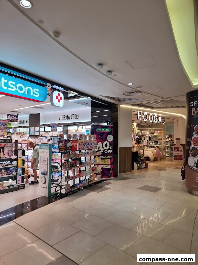 Exterior view of HOOGA and Watsons shops in a mall, with promotional signage.