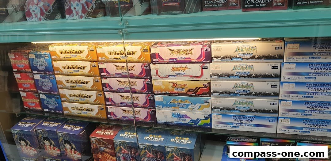 Shelves stocked with various trading card game booster boxes, including Digimon and One Piece.