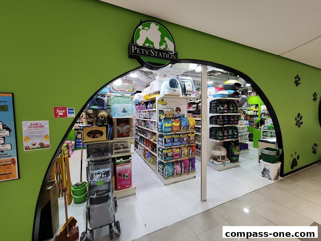 The entrance to a brightly lit pet store with shelves stocked with pet food and supplies.