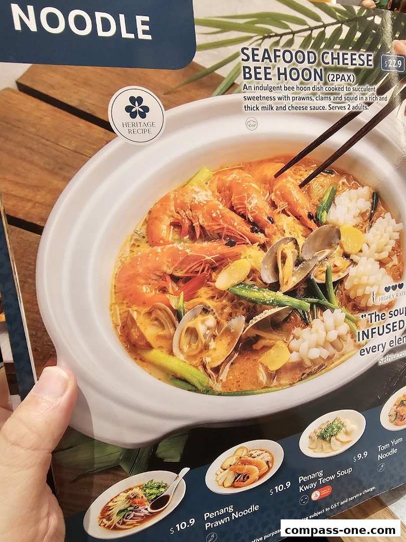A menu showcasing a Seafood Cheese Bee Hoon dish and other Penang noodle specialties.