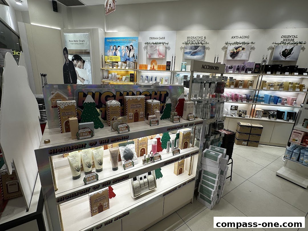 Interior view of a beauty store with shelves stocked with skincare products and holiday-themed displays.