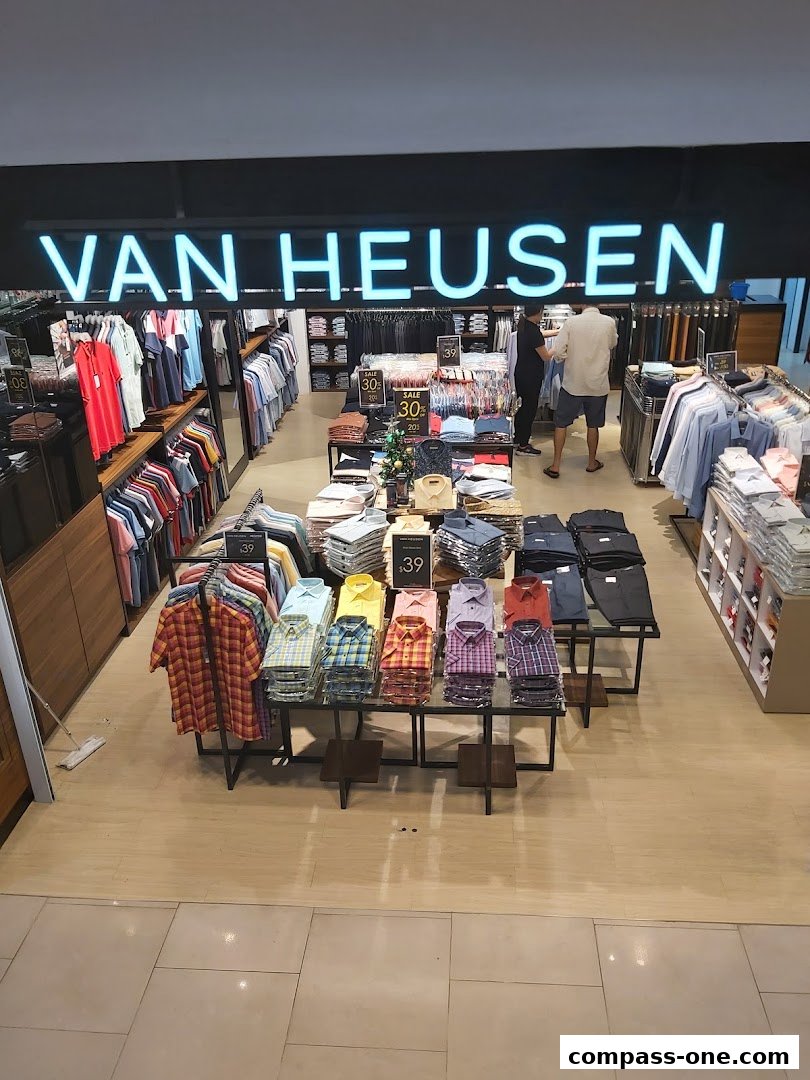 Interior view of a Van Heusen store showcasing a wide selection of men's shirts and apparel.