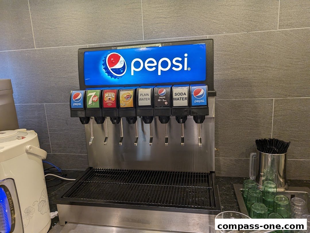 A Pepsi beverage dispenser with multiple drink options and cups.