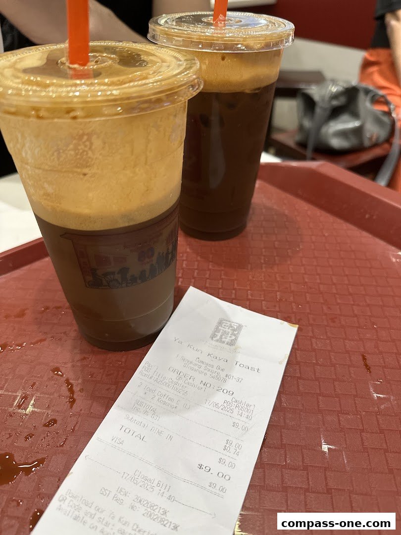 Two iced coffee drinks and a receipt from Ya Kun Kaya Toast on a red tray.