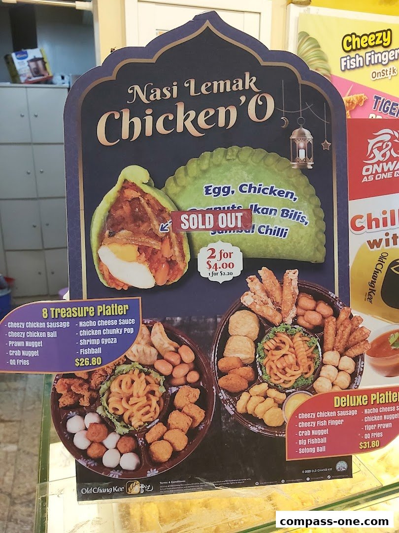 A display board showcasing Old Chang Kee's Nasi Lemak Chicken'O and platters with prices.