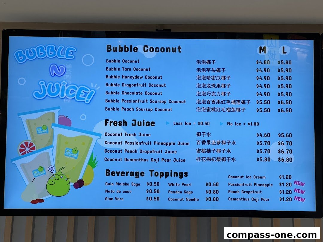 A digital menu board displaying various bubble tea and fresh juice options with prices.