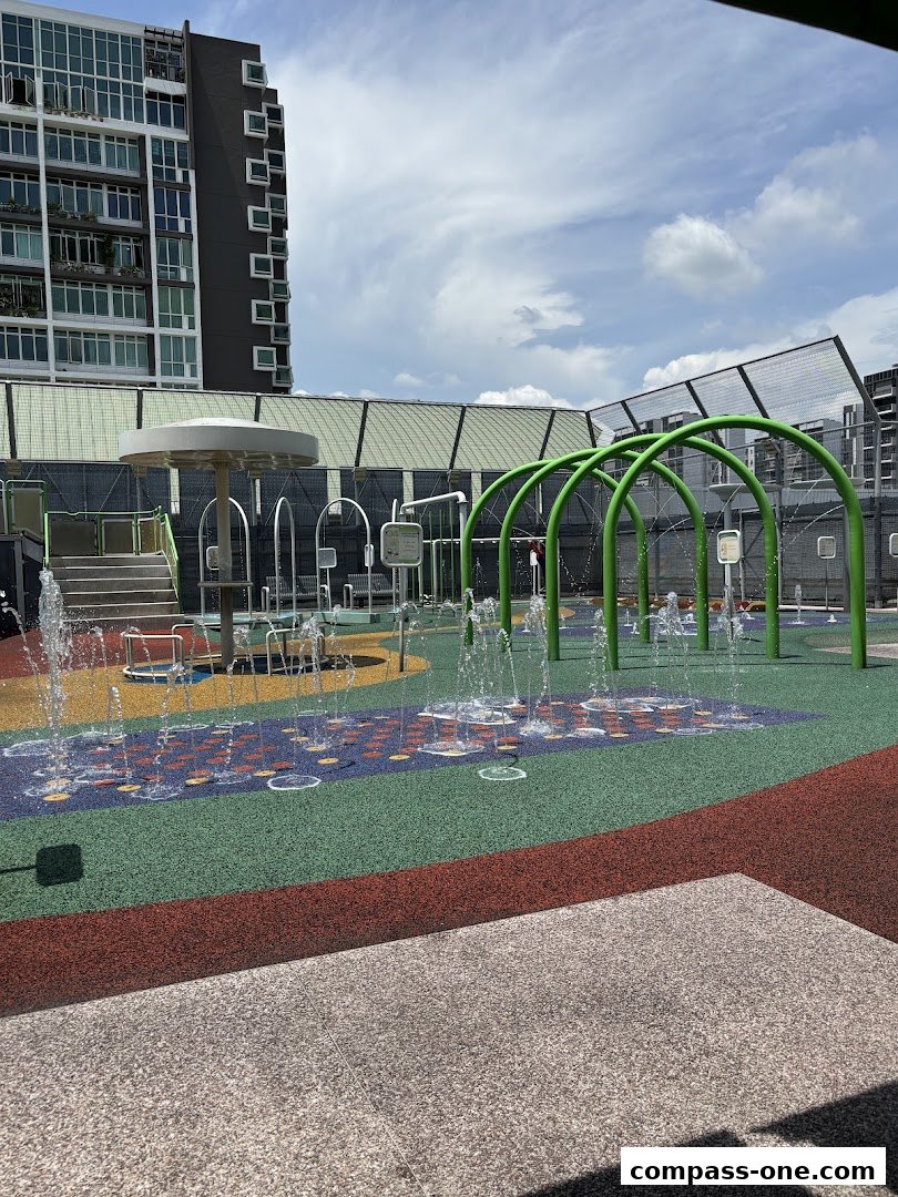 A vibrant water playground with colorful ground surfaces and water jets spraying.