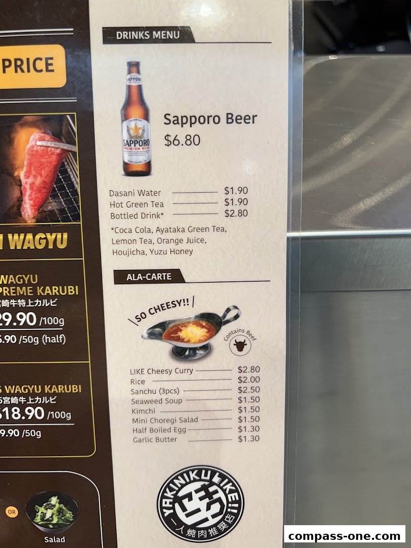A menu featuring Sapporo Beer, Wagyu Karubi, and ala-carte items like cheesy curry and side dishes.
