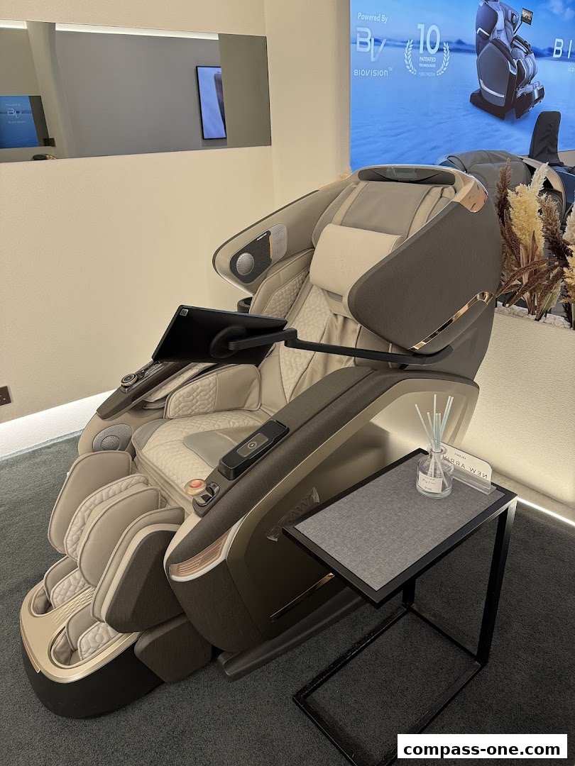 A luxurious massage chair with a tablet and a side table in a modern showroom.