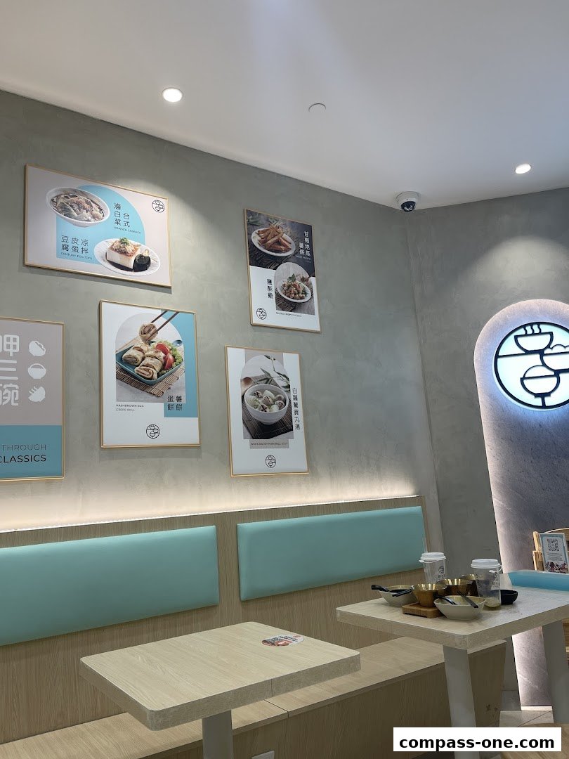 Interior of a restaurant with framed food pictures and seating.
