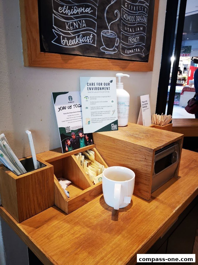 Starbucks counter with coffee beans listed on a chalkboard and a cup of tea.