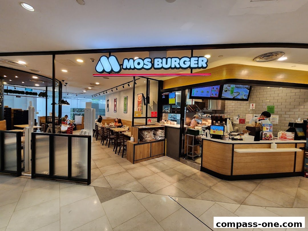 The exterior of a MOS Burger restaurant with seating area and counter.